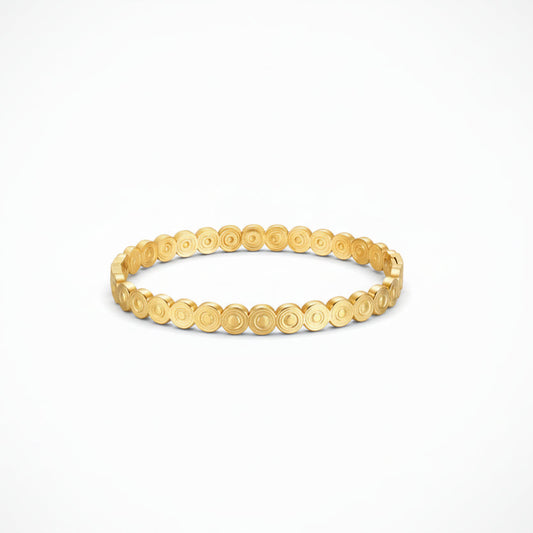 Gold bracelet with circular pattern on a white background