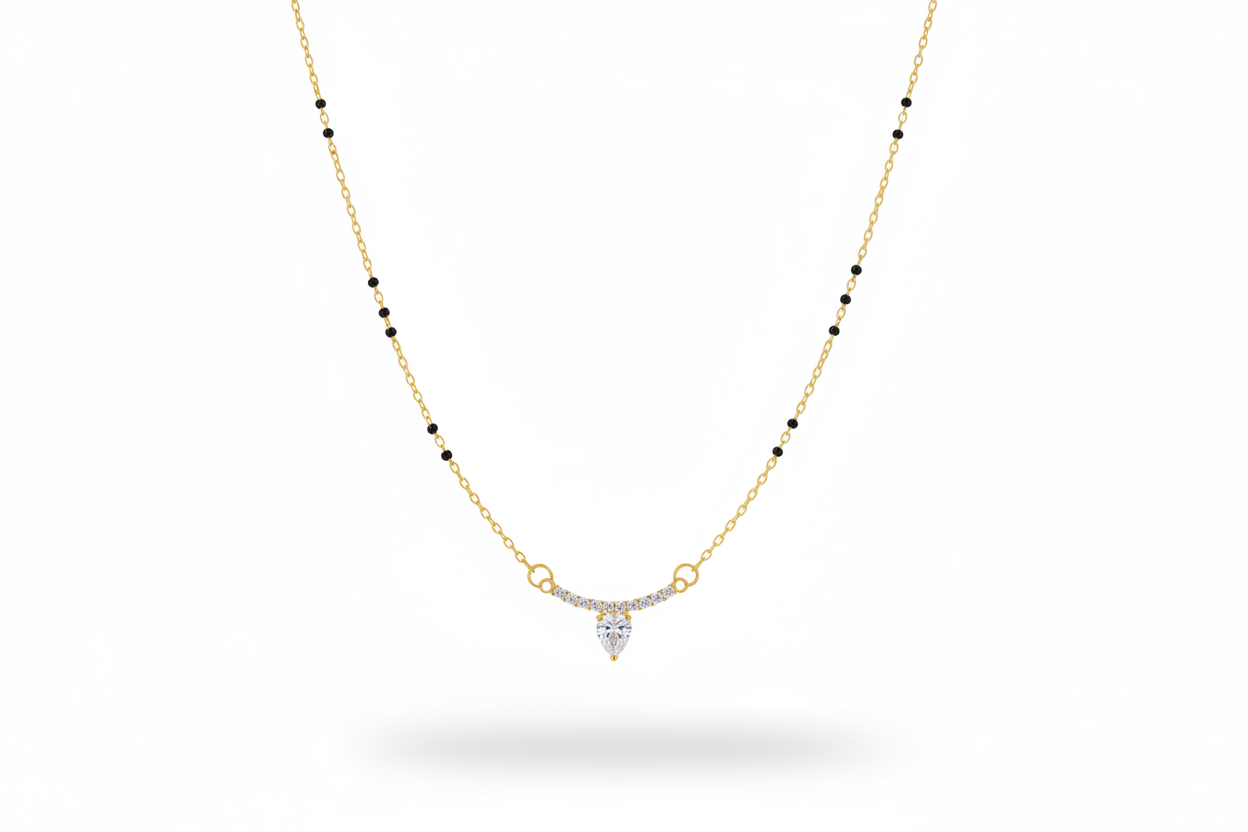 Gold necklace with a heart-shaped pendant on a neutral background